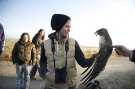 Student holding a hawk