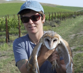 Carrie Wendt - Holding an owl in a vineyard