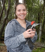 Dawn Blake in the forest with a bird